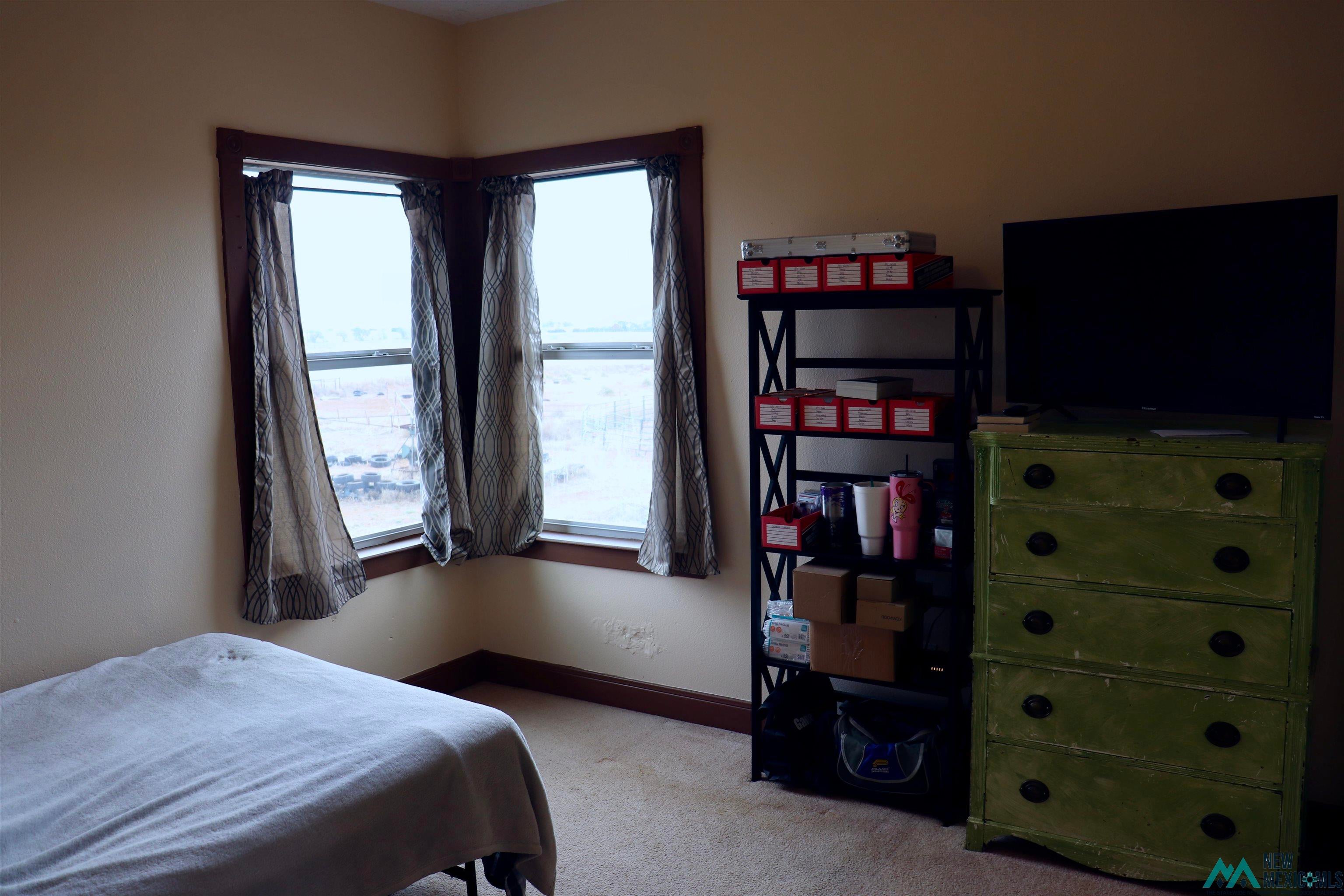 845 South Roosevelt Road South Portales, NM 88130 - Photo 20 of 47 Bedroom featuring light carpet and baseboards