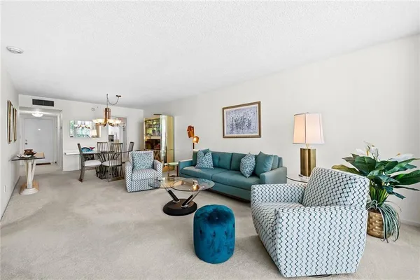 a view of a dining room with furniture and chandelier
