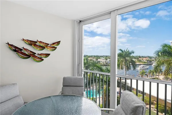 a living room with furniture and a floor to ceiling window