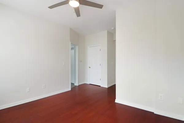 an empty room with a empty space and a ceiling fan