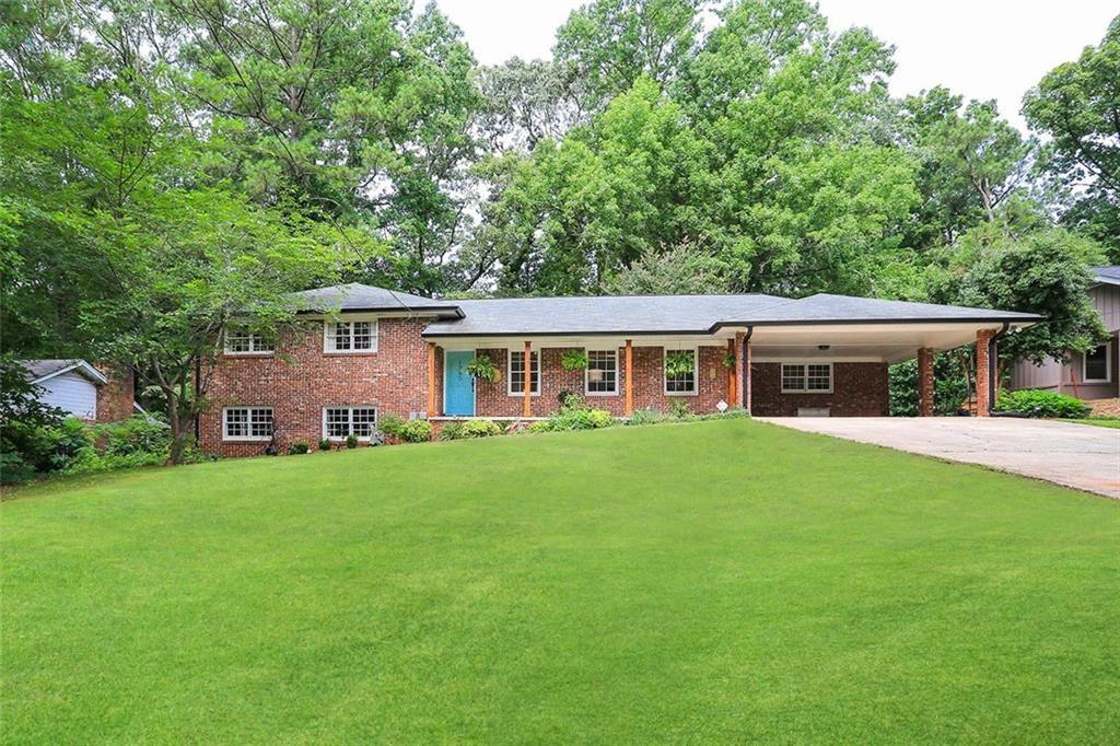 a front view of house with yard and green space