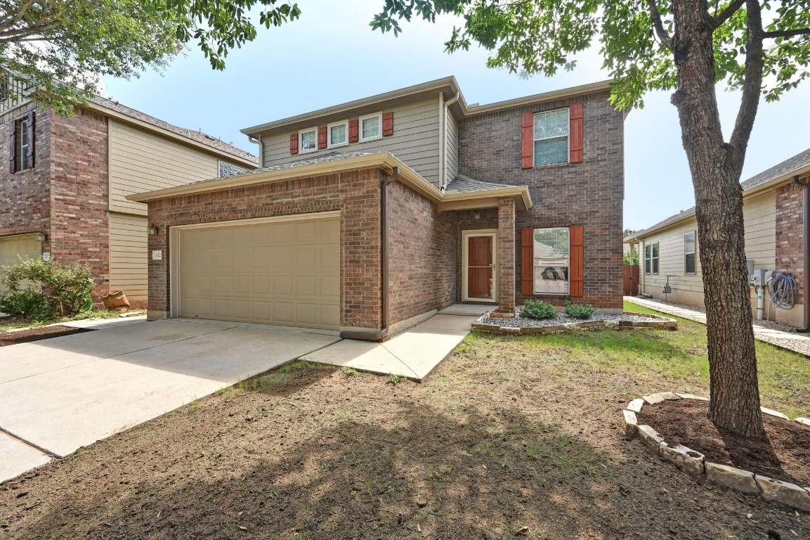 a view of a house with a yard and garage