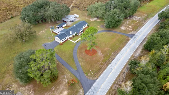 a view of a house with a swimming pool and sitting area