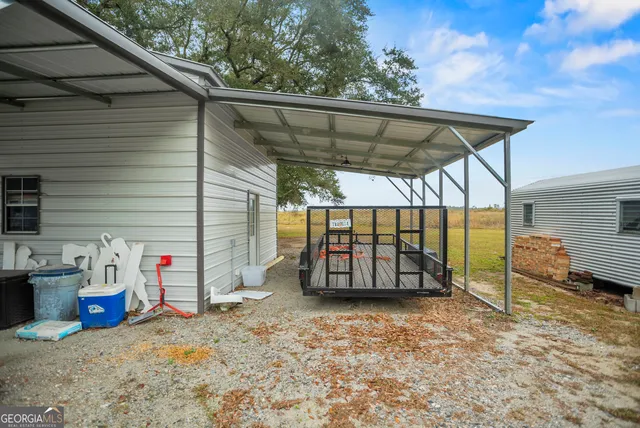 a kitchen with stainless steel appliances kitchen island a dining table and chairs