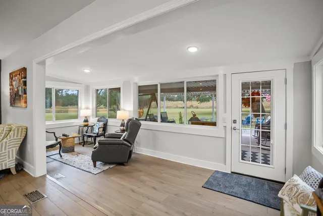 a living room with furniture and a lamp