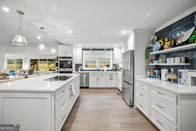 a kitchen with a stove a sink and a refrigerator