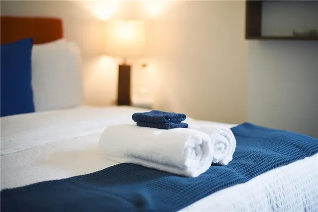 a bedroom with a bed and a night stand