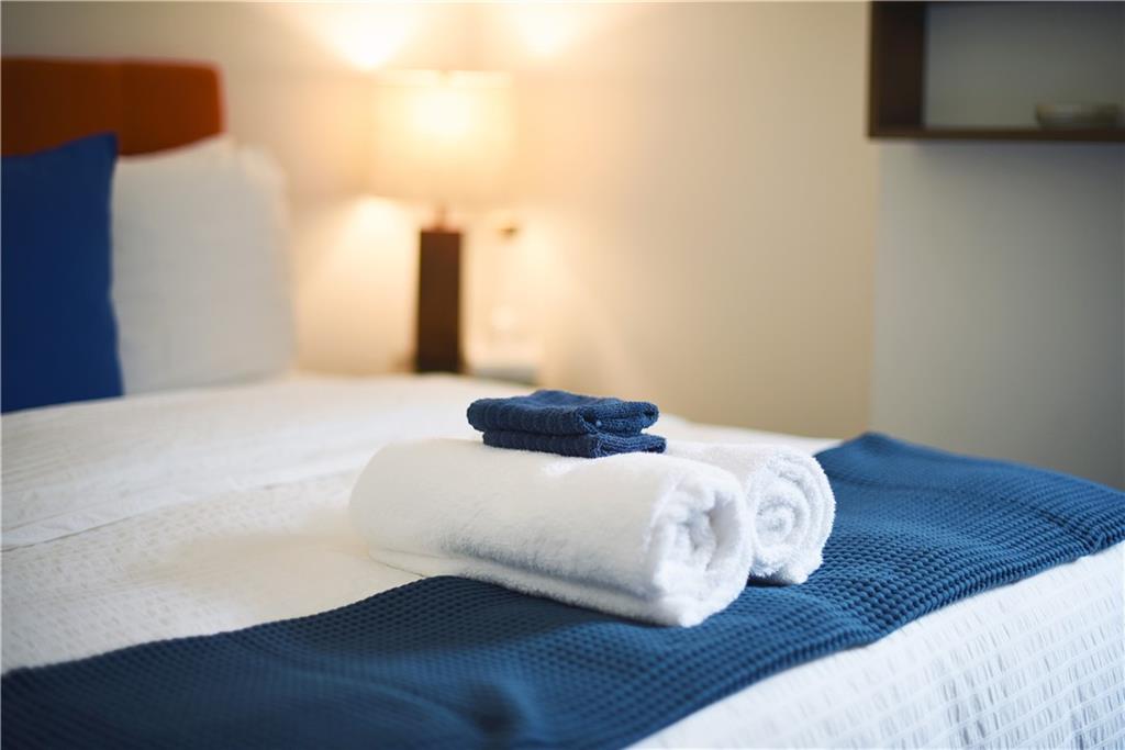 103 57th Street Pittsburgh, PA 15201 - Photo 13 of 49 a bedroom with a bed and a night stand