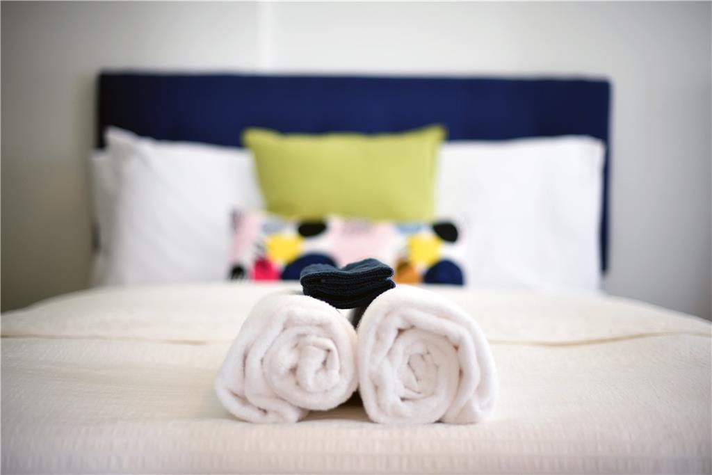 103 57th Street Pittsburgh, PA 15201 - Photo 14 of 49 a bedroom with a bed and lamp