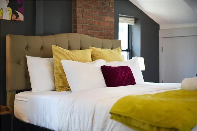 a bed sitting in a bedroom next to a window