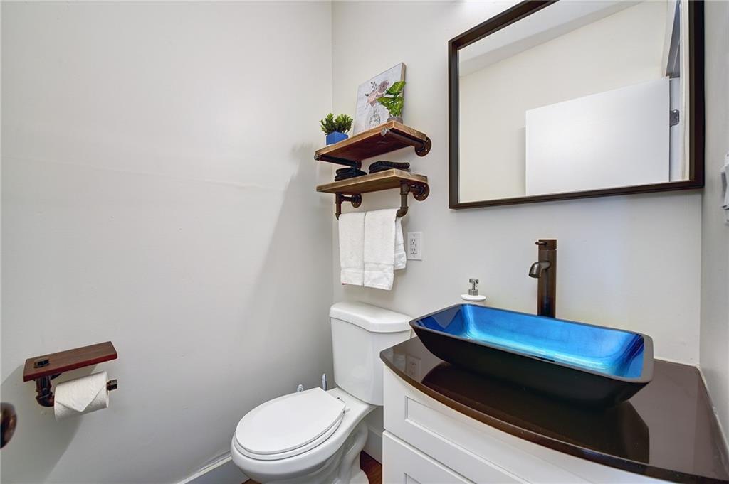 103 57th Street Pittsburgh, PA 15201 - Photo 31 of 49 a bathroom with a toilet a sink and mirror