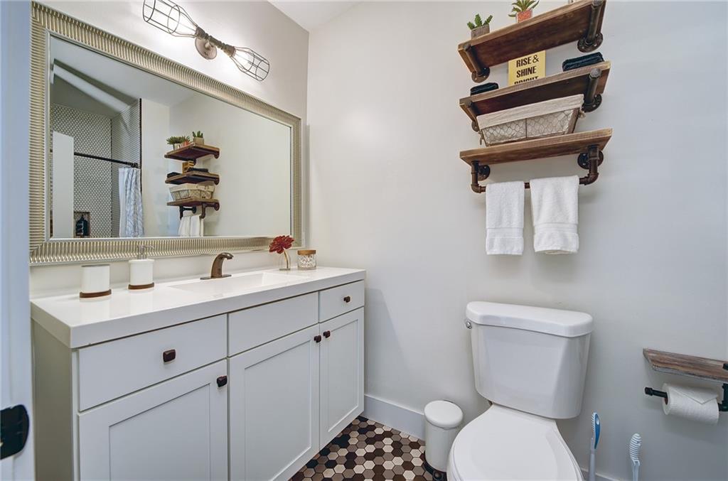 103 57th Street Pittsburgh, PA 15201 - Photo 32 of 49 a bathroom with a toilet a sink and mirror