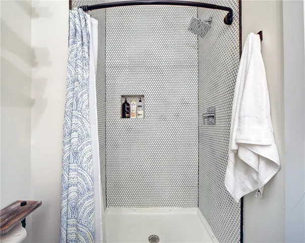 a bathroom with a bathtub and shower