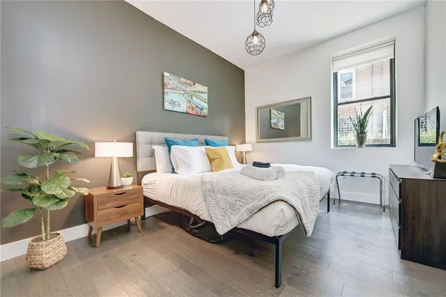 a bedroom with a bed and window