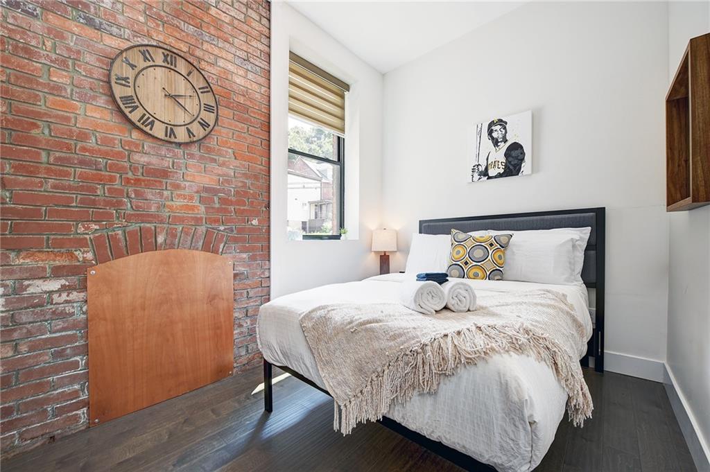 103 57th Street Pittsburgh, PA 15201 - Photo 40 of 49 a bedroom with a bed and a table in it