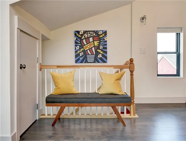 a view of room with furniture and wooden floor