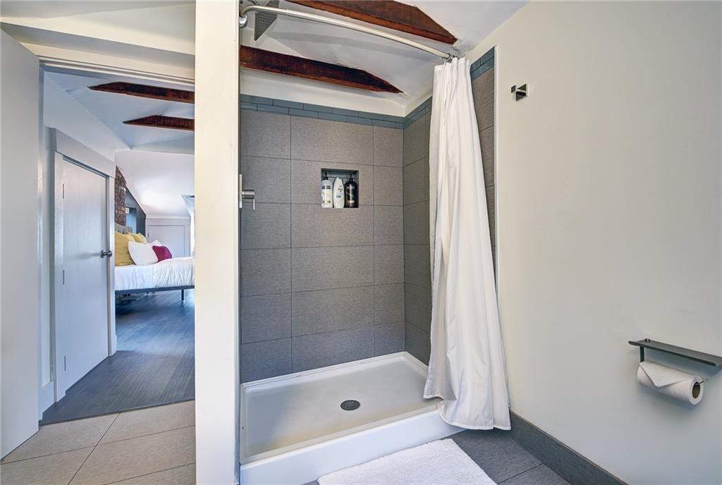 103 57th Street Pittsburgh, PA 15201 - Photo 45 of 49 a bathroom with a tub and a shower