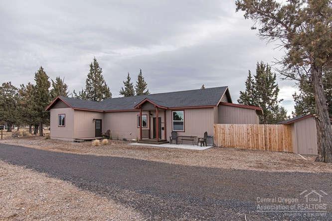 23095 Alfalfa Market Road Bend, OR 97701 - Photo 17 of 25 a house with trees in front of it