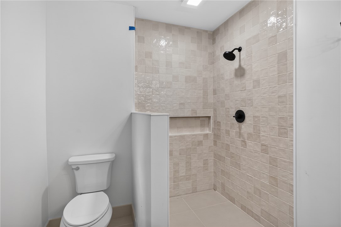 304 Lakeside Drive Seneca, SC 29672 - Photo 30 of 49 A well-appointed shower space, featuring modern tiling and sleek black fixtures for a clean aesthetic.