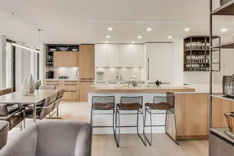 a kitchen with stainless steel appliances kitchen island granite countertop a sink and cabinets