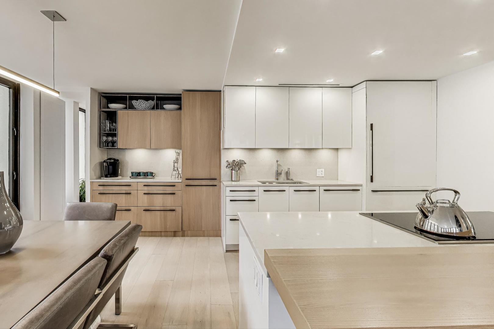 100 East Walton Street, Unit 15DE Chicago, IL 60611 - Photo 21 of 26 a kitchen with a refrigerator a sink and white cabinets