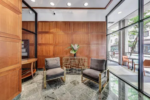 a living room with furniture a rug and a window