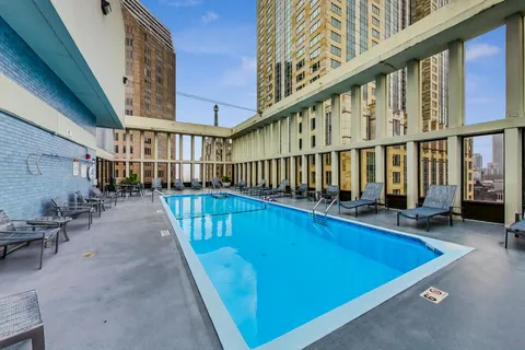 a view of swimming pool with outdoor seating