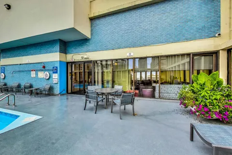 a view of a patio with table and chairs potted plants and wooden fence