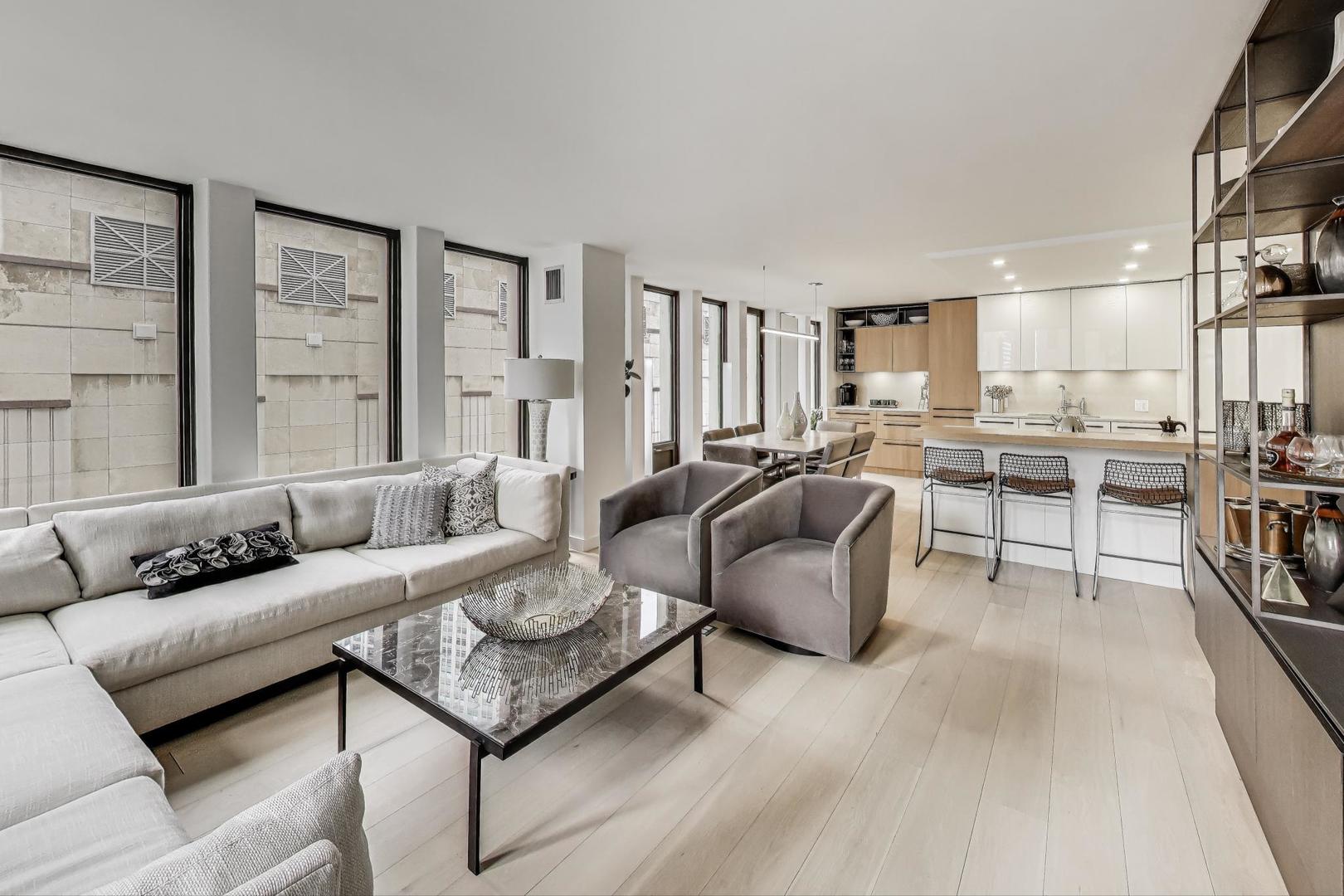 100 East Walton Street, Unit 15DE Chicago, IL 60611 - Photo 7 of 26 a living room with furniture kitchen view and large windows
