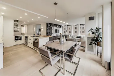 a large kitchen with a table and chairs