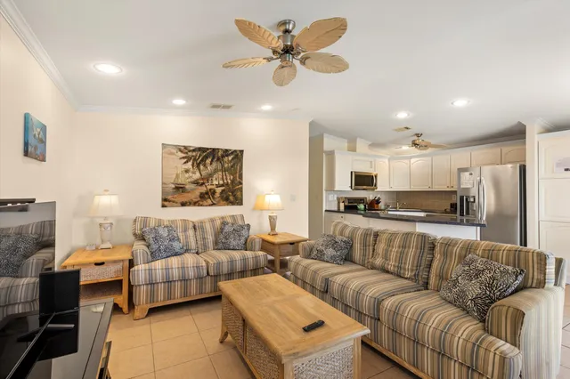a living room with furniture and kitchen view