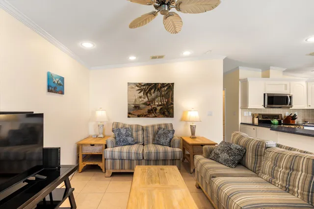 a living room with furniture wooden floor and a large window