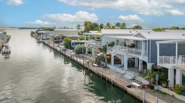 an aerial view of multiple houses with a yard