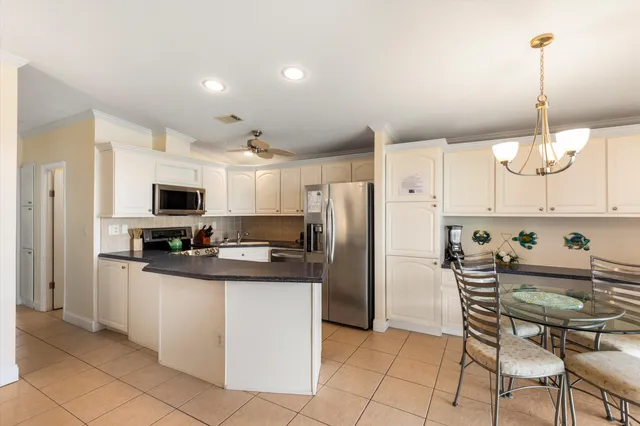 a kitchen with stainless steel appliances granite countertop a refrigerator sink and cabinets