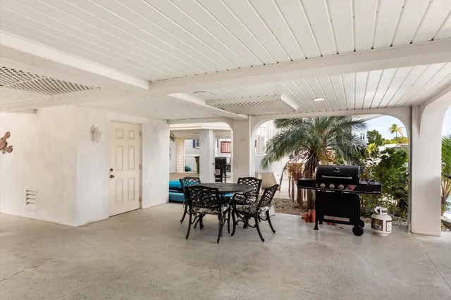 a view of a dining room with furniture large windows and wooden floor