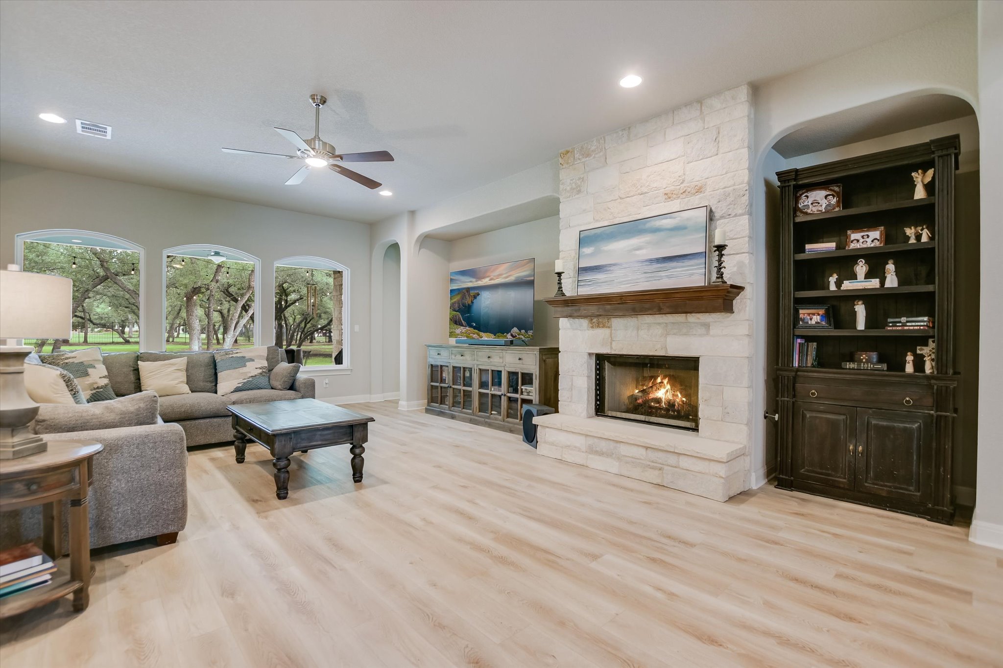 2561 Ridley House Cove Leander, TX 78641 - Photo 5 of 36 Living area featuring tile flooring and a stone-clad fireplace with a wood mantel