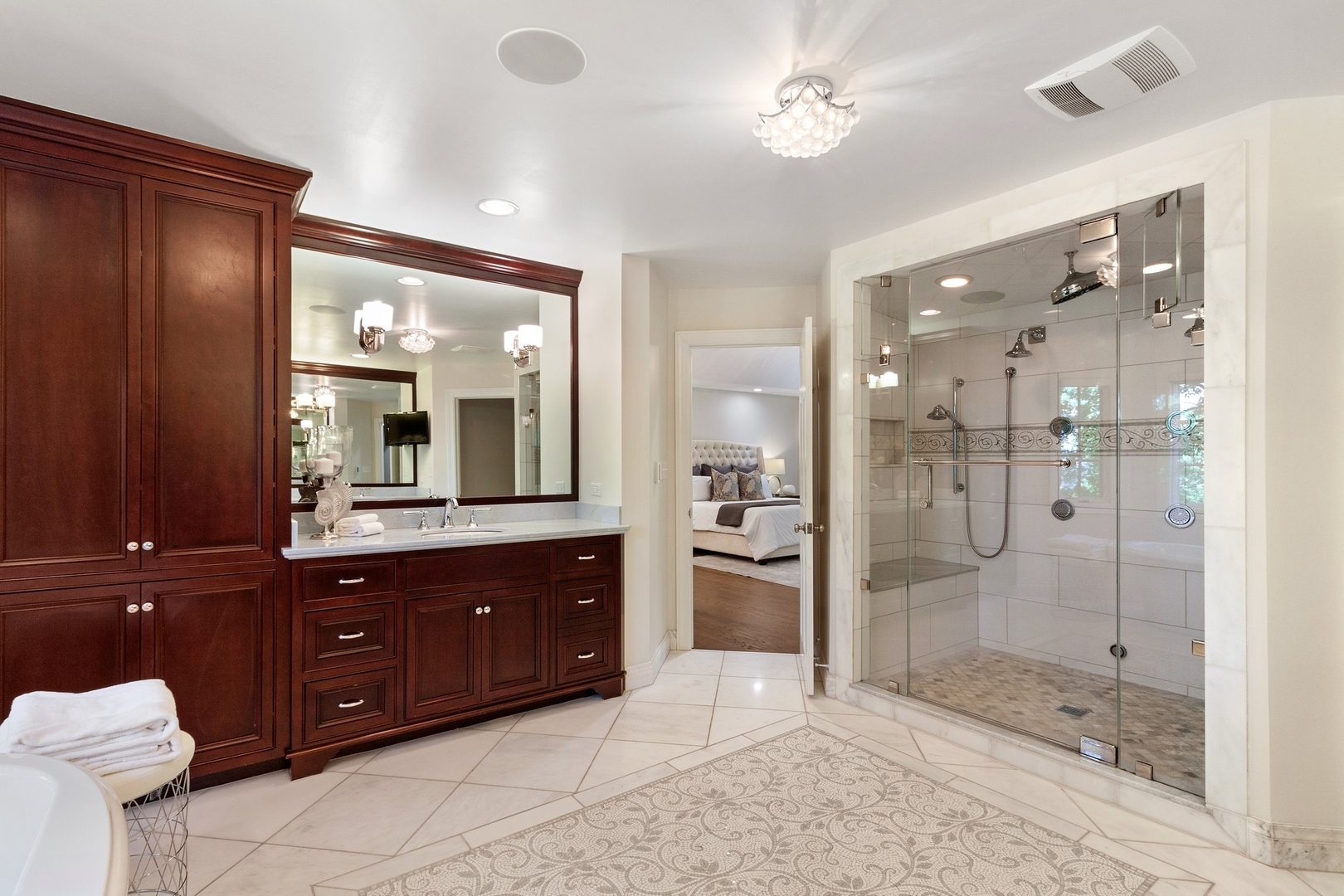 25 South County Line Road Hinsdale, IL 60521 - Photo 22 of 44 a bathroom with a glass shower door and a sink