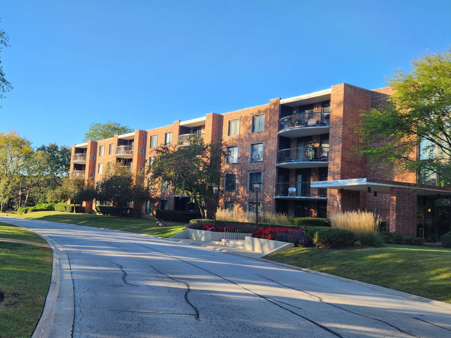 1605 East Central Road, Unit 410B Arlington Heights, IL 60005 - Photo 1 of 18 a view of a building with a yard
