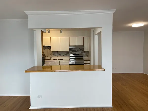 a view of a living room with kitchen island granite countertop wooden floor