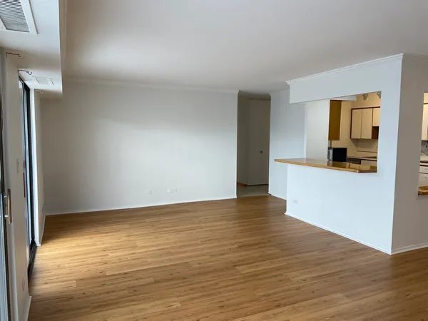 a view of a kitchen with wooden floor and a sink