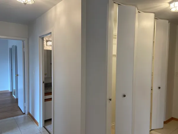a view of a hallway with windows and entryway