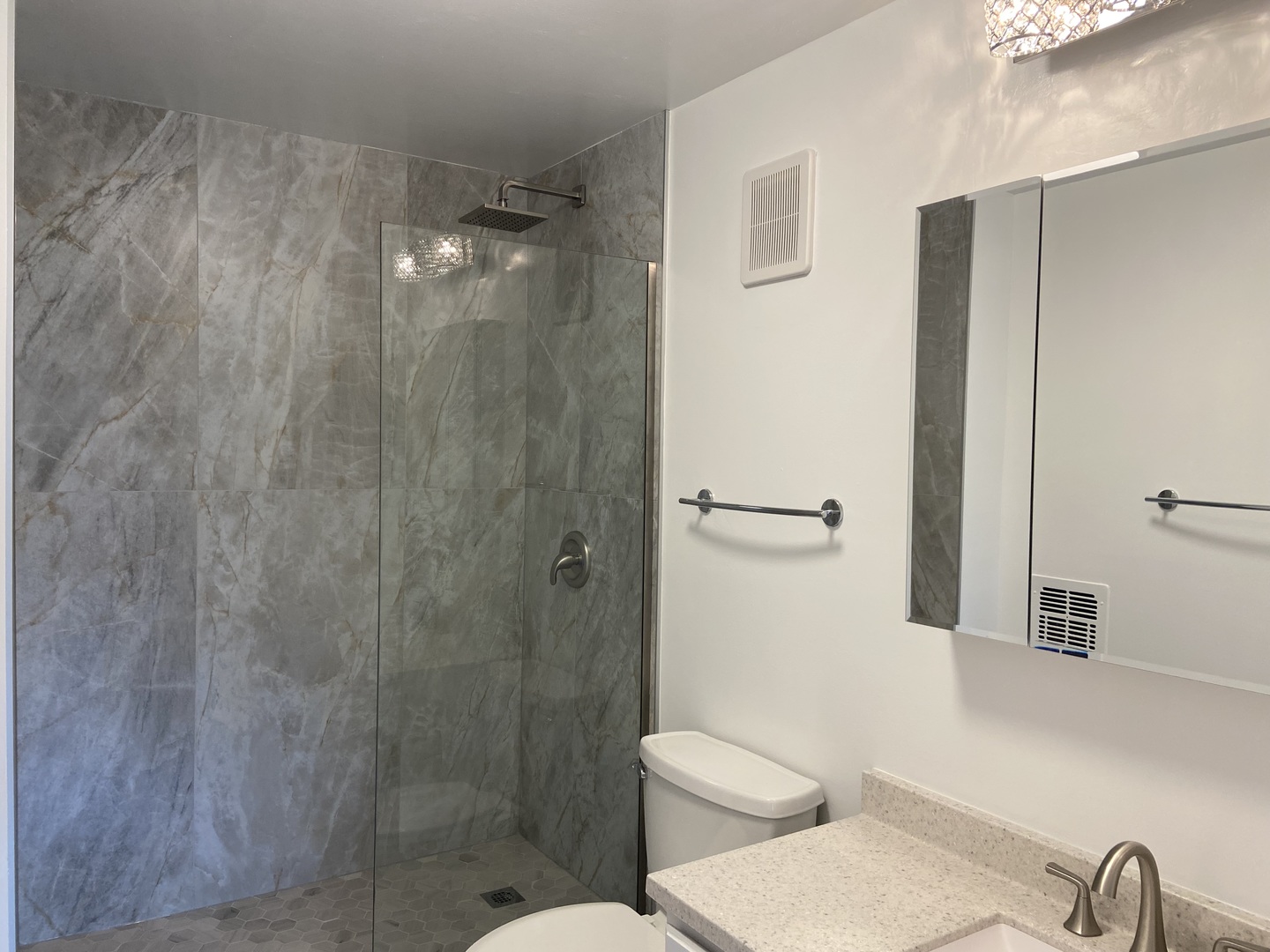 1605 East Central Road, Unit 410B Arlington Heights, IL 60005 - Photo 10 of 18 a bathroom with a toilet a sink and shower