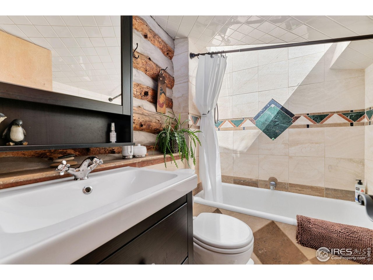501 Main Street Boulder, CO 80302 - Photo 28 of 45 a bathroom with a sink a mirror and a bathtub