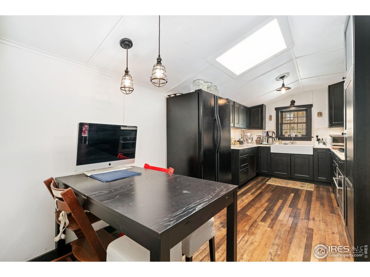 501 Main Street Boulder, CO 80302 - Photo 9 of 45 a kitchen with a table chairs refrigerator and microwave