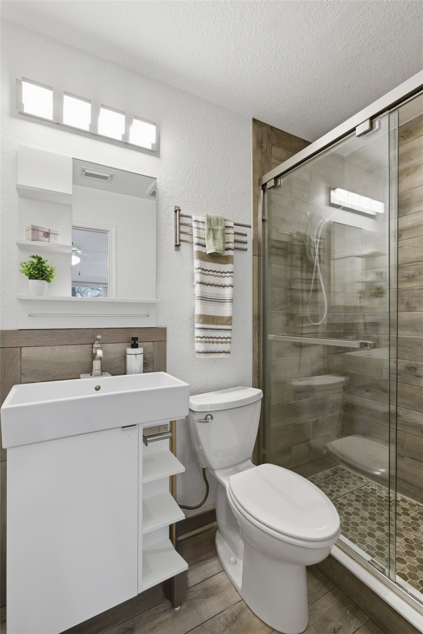 112 Prairie Springs Loop Georgetown, TX 78626 - Photo 11 of 23 a bathroom with a sink a toilet a mirror and shower