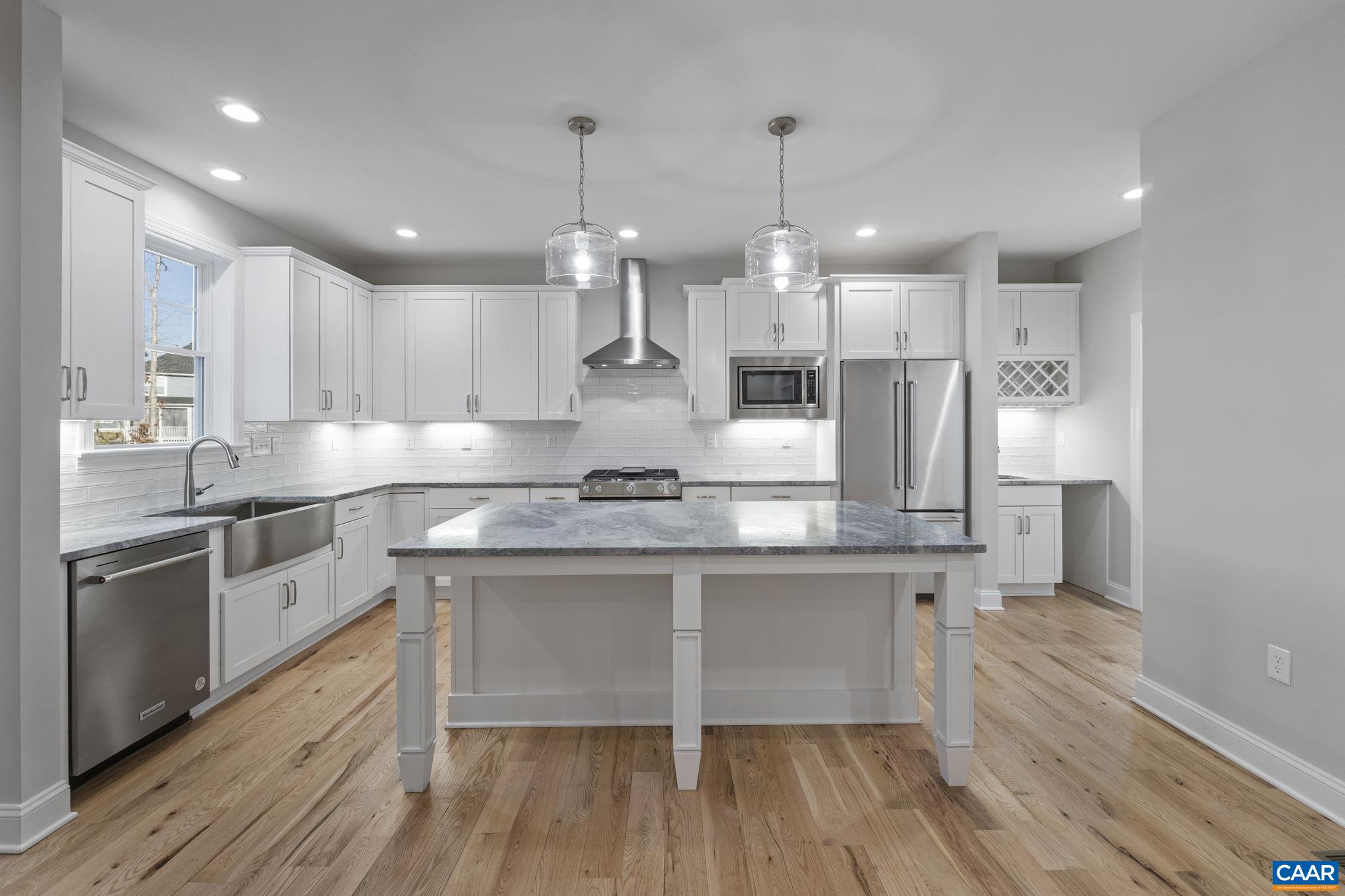2230 Fowler Circle Charlottesville, VA 22901 - Photo 21 of 58 a large kitchen with cabinets wooden floor and stainless steel appliances