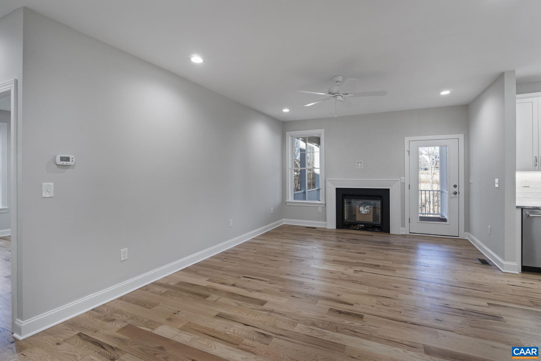 2230 Fowler Circle Charlottesville, VA 22901 - Photo 32 of 58 an empty room with wooden floor fireplace and windows