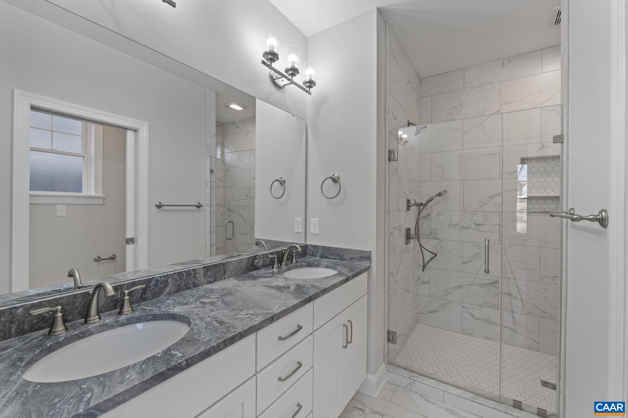 2230 Fowler Circle Charlottesville, VA 22901 - Photo 38 of 58 a bathroom with a granite countertop sink a mirror a shower and a bathtub