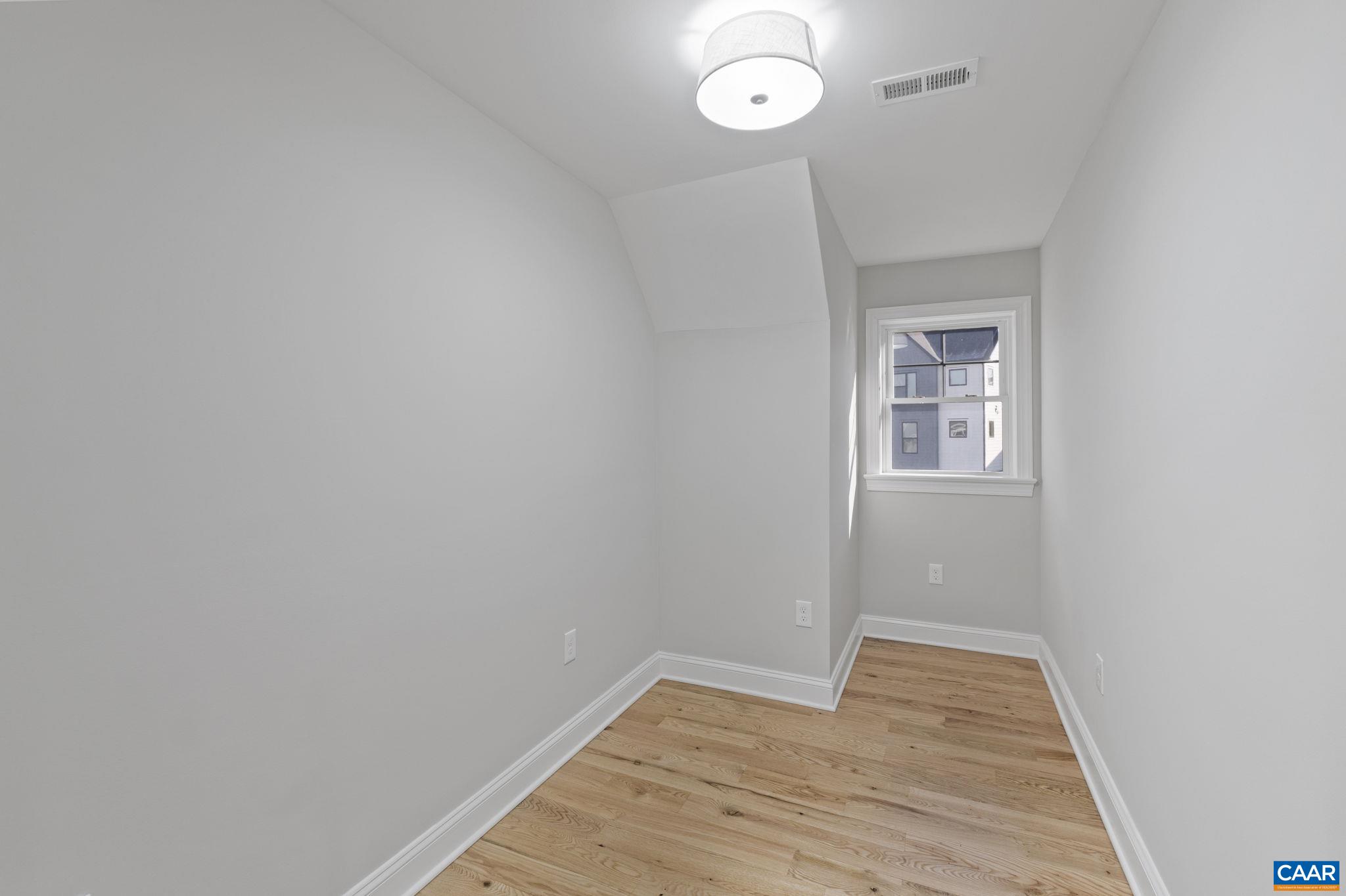 2230 Fowler Circle Charlottesville, VA 22901 - Photo 47 of 58 an empty room with wooden floor and windows
