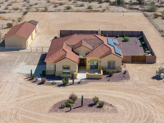 a view of swimming pool with outdoor seating and house in the background